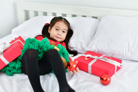 Little girl celebrates Christmas with red Santa dress.の写真素材