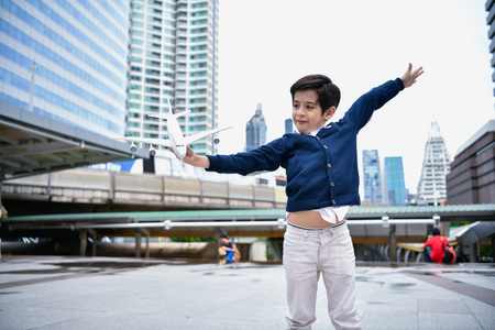Children's play concept. The boy is playing with toys. Boy playing toy in the city.の写真素材