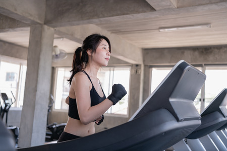 Exercise concept. Attractive young sports woman is working out in gym. Doing cardio training on...