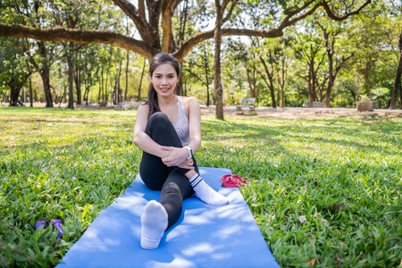Concept of exercise. Beautiful girl stretching the muscles before running. Women exercising in the...