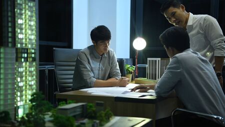 Business concept. The young engineer is discussing the construction project in the office.の写真素材