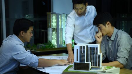 Business concept. The young engineer is discussing the construction project in the office.の写真素材