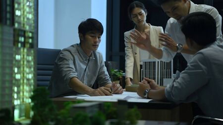 Business concept. Architects are working to fix the orders of customers outside of working hours.