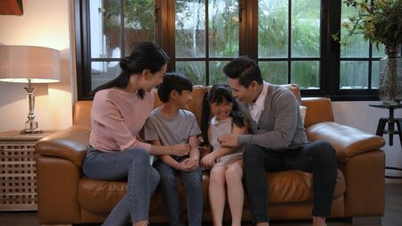 Holiday concept. The family is playing on the sofa in the living room. 4k Resolution.