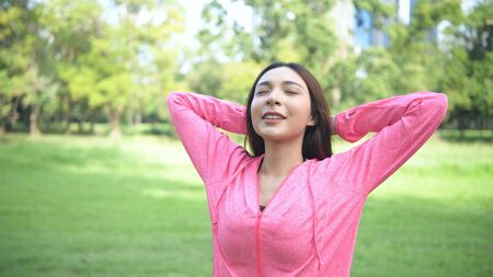 Exercise concepts. The young athlete is breathing freshly in the garden. 4k Resolution.
