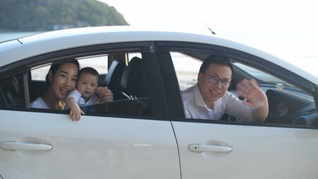 Holiday concept. The family waved goodbye inside the white car on the beach. 4k Resolution.