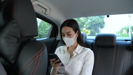 Travel Concept. The masked woman is traveling to the doctor at the hospital.の写真素材