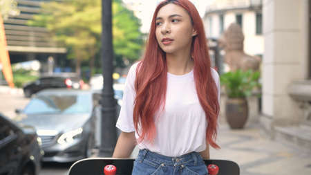 Independent concept. Indie girl walking in town. 4k Resolution.の写真素材