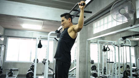 Exercise concepts. Asian men are exercising their back muscles with a bar. 4k Resolution.