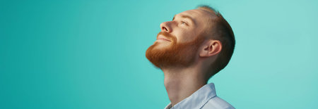 Caucasian man wearing shirt on blue background.の素材