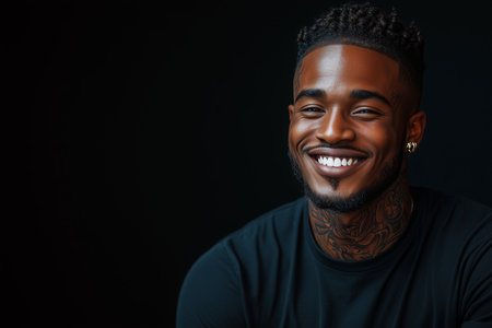 African American man has tattoos on his body on black background.の素材