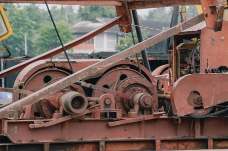Close-up of vintage machinery showcasing gears and pulleys, highlighting the mechanics of industrial environments.の写真素材