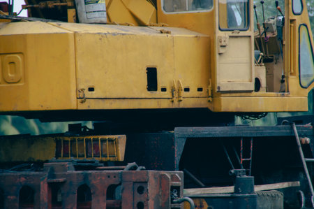 A close-up view of a yellow industrial crane showcasing its structure and machinery components.の写真素材