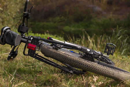 Bicycle lying on the grass in the summer.の写真素材