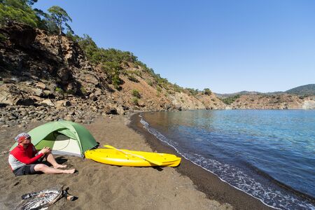 Kayak on the beach on a sunny day near the tent.の写真素材