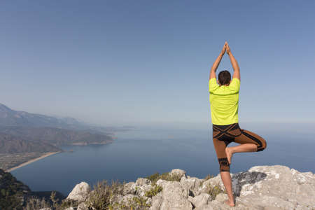 Young man on a mountain top on a sunny day.の写真素材