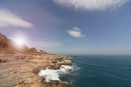Beautiful sea paradise beach on a background of blue sky with clouds.
