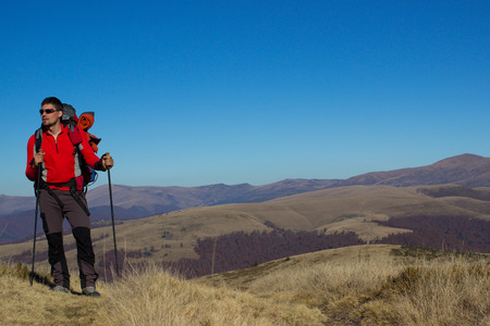 Hiker trekking in the mountains a sunny day.の写真素材