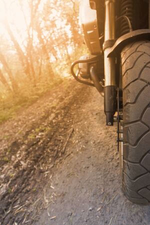 The motorcycle is on the road on a sunny day.