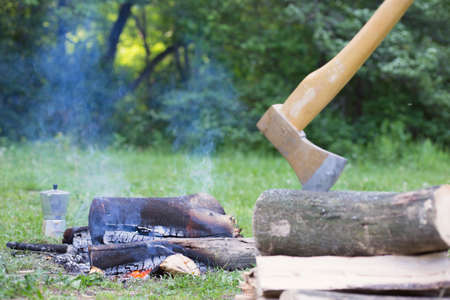 Camping in the woods with a fire in the wood on the bank of the river.の写真素材