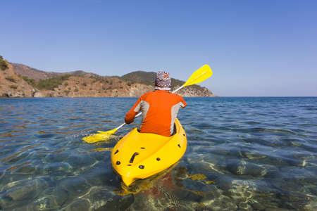 Men travel by canoe on the sea in the summer.の写真素材