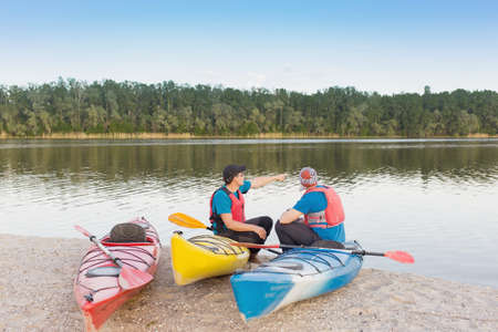 Men travel by canoe on the river in the summer a sunny day.の写真素材