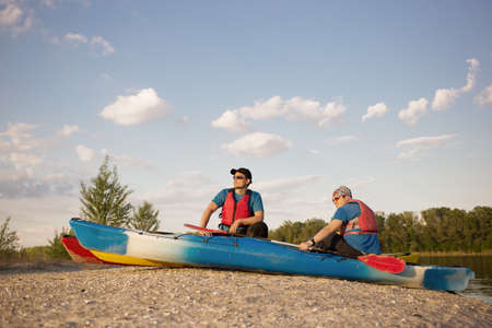 Men travel by canoe on the river in the summer a sunny day.の写真素材