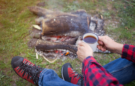 Man in camping in the woods in summer.