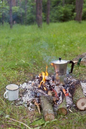 Cooking coffee over an open fire in the forest.の写真素材