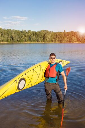 Man traveling on the river in a kayak in the summer.の写真素材