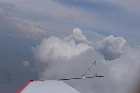 Flying on a plane between the beautiful clouds.の写真素材