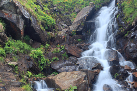 Beautiful cascading full-flowing waterfall in the mountains.の写真素材