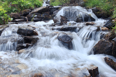Beautiful cascading full-flowing waterfall in the mountains.の写真素材