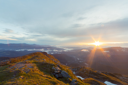 A beautiful sunrise overlooking the mountains in the summer.の写真素材