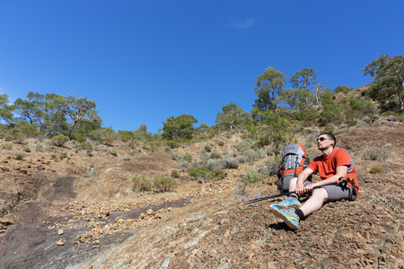 Man hiking in the mountains on a sunny day.の写真素材