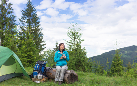 Camping in the mountains with a tent in the summer.の写真素材