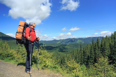 Man hiking in the mountains on a sunny day.の写真素材