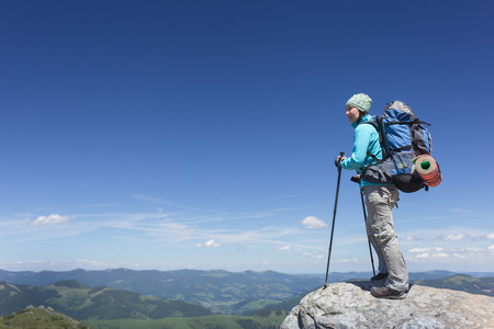 Girl with a backpack in a mountain hike in the summer.の写真素材