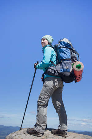 Girl with a backpack in a mountain hike in the summer.の写真素材