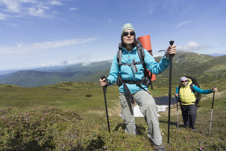 Hiking in the mountains in the summer on a sunny day.の写真素材