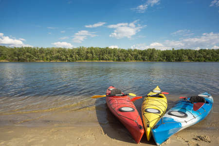 Camping with kayaks on the beach on a sunny day.の写真素材