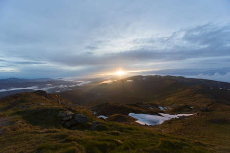 A beautiful sunrise overlooking the mountains in the summerの写真素材