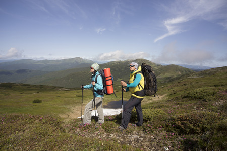 Hiking in the mountains in the summer on a sunny day.の写真素材