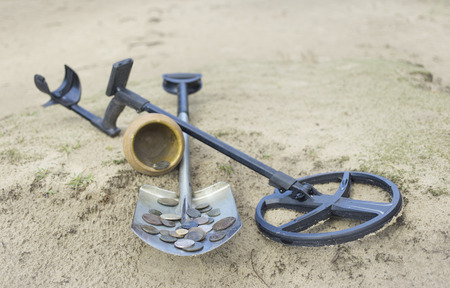 Search for treasure using a metal detector and shovel.の写真素材