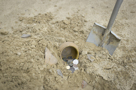 Search for treasure using a metal detector and shovel.の写真素材
