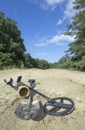 Search for treasure using a metal detector and shovel.の写真素材