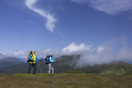 Hiking in the mountains in the summer on a sunny day.の写真素材