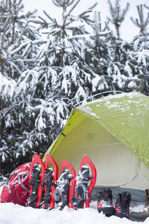 Camping in the winter campaign of winter with snowshoes and tent.の写真素材