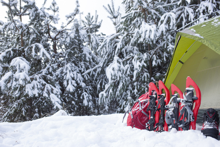 Camping in the winter campaign of winter with snowshoes and tent.の写真素材