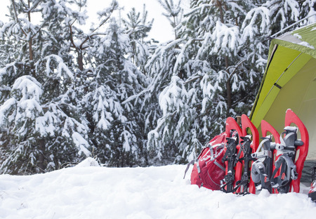 Camping in the winter campaign of winter with snowshoes and tent.の写真素材